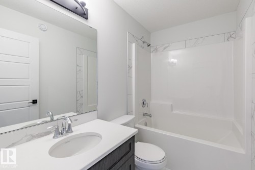 Bathroom featuring vanity and bathing tub / shower combination - 75 Dansereau Way, Beaumont, AB - Indoor Photo Showing Bathroom