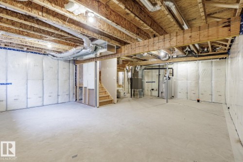 Unfinished basement featuring heating unit and gas water heater - 75 Dansereau Way, Beaumont, AB - Indoor Photo Showing Basement