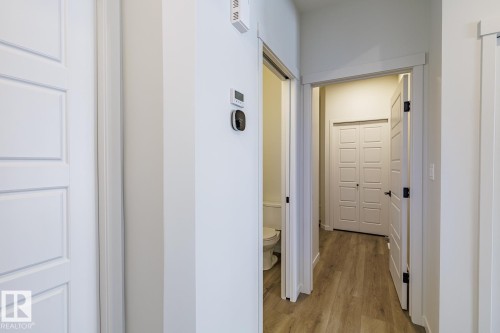 Hall featuring light wood-type flooring - 75 Dansereau Way, Beaumont, AB - Indoor Photo Showing Other Room