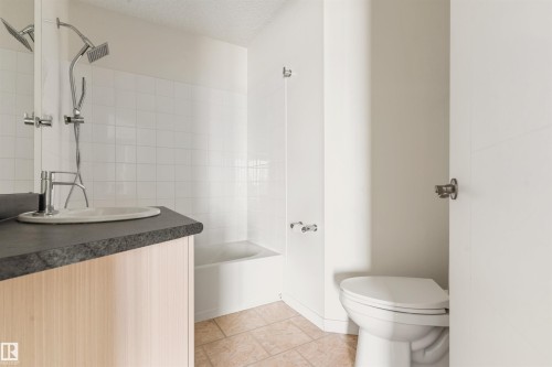 Full bathroom featuring vanity, a textured ceiling, and  shower combination - 312 11620 9A Avenue, Edmonton, AB - Indoor Photo Showing Bathroom