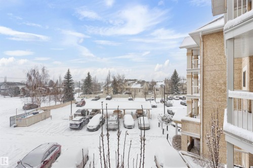 View of snowy yard - 312 11620 9A Avenue, Edmonton, AB - Outdoor With Balcony