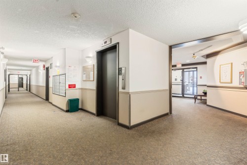 Hall with elevator and a textured ceiling - 312 11620 9A Avenue, Edmonton, AB - Indoor