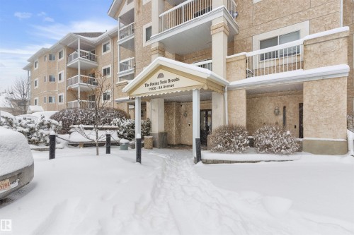 Snow covered building featuring a view of apartment building / complex - 312 11620 9A Avenue, Edmonton, AB - Outdoor With Balcony With Facade