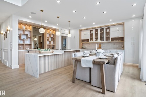 Kitchen featuring open shelves, light wood-style floors, backsplash, light stone countertops, and decorative light fixtures - 7026 Kiviaq Crescent, Edmonton, AB - Indoor Photo Showing Kitchen With Upgraded Kitchen