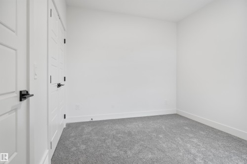 Carpeted empty room with baseboards - 7026 Kiviaq Crescent, Edmonton, AB - Indoor Photo Showing Other Room
