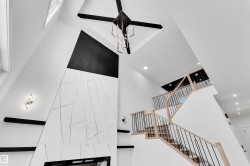 Stairway featuring a high ceiling and recessed lighting - 