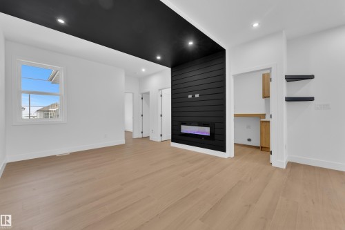 Unfurnished living room featuring a fireplace, light wood finished floors, and recessed lighting - 741 Astoria Way, Devon, AB - Indoor