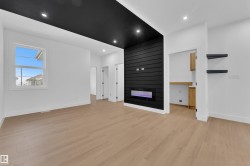 Unfurnished living room featuring a fireplace, light wood finished floors, and recessed lighting - 
