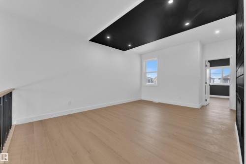 Unfurnished living room with light wood finished floors, plenty of natural light, and recessed lighting - 741 Astoria Way, Devon, AB - Indoor Photo Showing Other Room