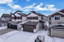 View of front of house with a residential view, a shingled roof, and an attached garage - 741 Astoria Way, Devon, AB  - Outdoor With Facade 
