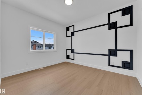 Spare room with baseboards and light wood-style flooring - 741 Astoria Way, Devon, AB - Indoor Photo Showing Other Room