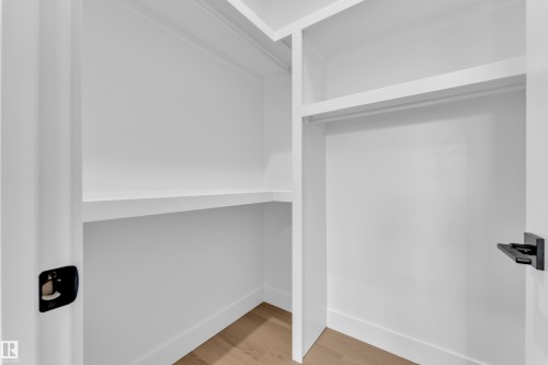 Walk in closet with light wood-style flooring - 741 Astoria Way, Devon, AB - Indoor