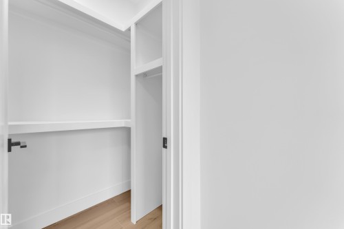 Walk in closet with light wood-type flooring - 741 Astoria Way, Devon, AB - Indoor