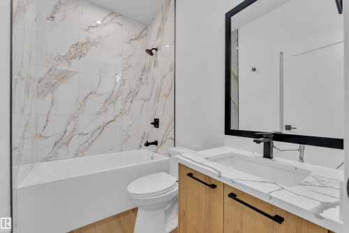 Bathroom featuring vanity, bathtub / shower combination, and light wood-style floors - 741 Astoria Way, Devon, AB - Indoor Photo Showing Bathroom