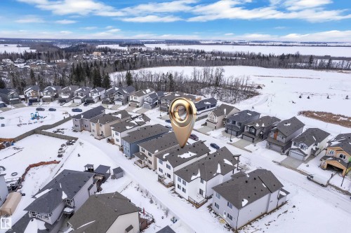 Snowy aerial view featuring a residential view - 741 Astoria Way, Devon, AB - Outdoor With View