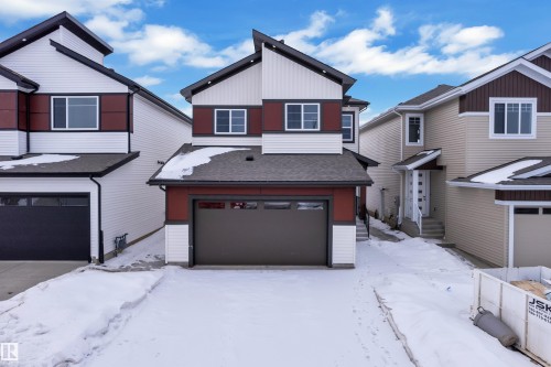 View of front of home with a shingled roof and an attached garage - 741 Astoria Way, Devon, AB - Outdoor