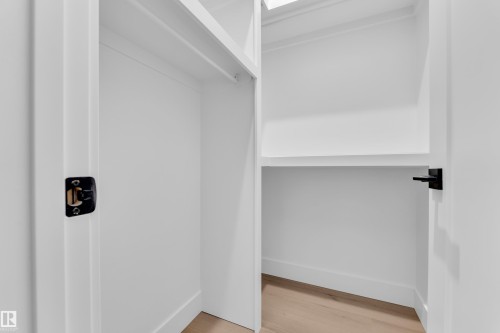 Walk in closet with light wood-style floors - 215 Basin Court, Leduc, AB - Indoor
