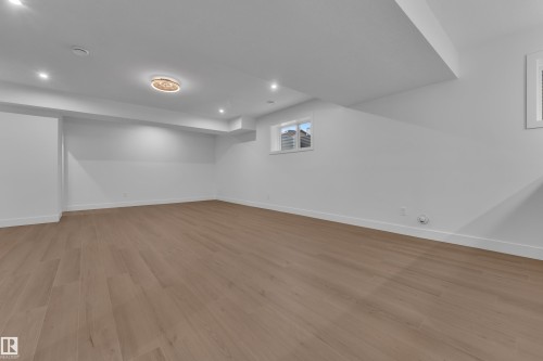 Basement featuring light wood finished floors and recessed lighting - 215 Basin Court, Leduc, AB - Indoor Photo Showing Other Room