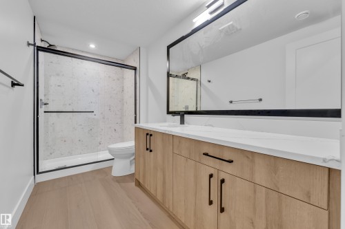 Bathroom featuring vanity, a shower stall, light wood finished floors, and recessed lighting - 215 Basin Court, Leduc, AB - Indoor Photo Showing Bathroom