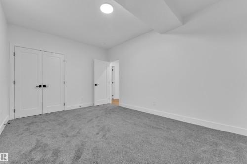 Unfurnished bedroom with carpet flooring and a closet - 215 Basin Court, Leduc, AB - Indoor Photo Showing Other Room