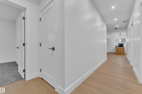 Hall with recessed lighting and light wood finished floors - 215 Basin Court, Leduc, AB - Indoor Photo Showing Other Room
