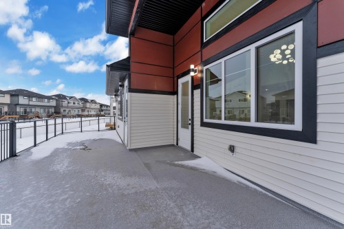 View of patio / terrace featuring a residential view - 215 Basin Court, Leduc, AB - Outdoor With Exterior