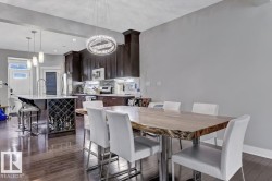 Dining space featuring dark wood-type flooring and a chandelier - 