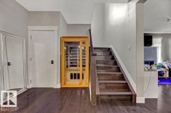 Staircase featuring a relaxing sauna and wood-type flooring - 