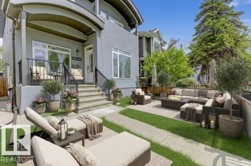 Back of house with outdoor seating, a patio area, and stucco siding - 10806 72 Avenue, Edmonton, AB - Outdoor