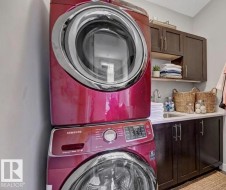 Laundry area with cabinet space and stacked washer and dryer - 