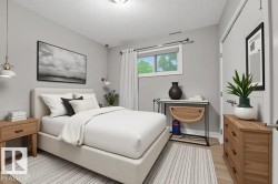 Bedroom with a textured ceiling and light wood-style floors - 
