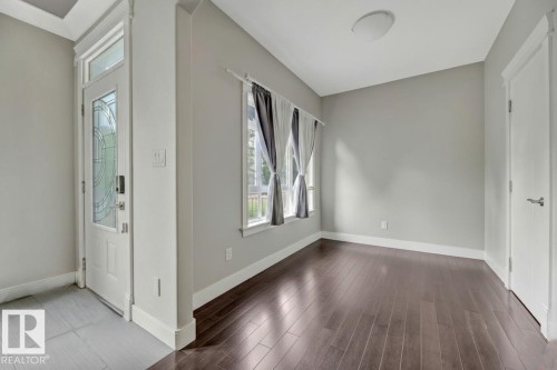 Entryway featuring baseboards and dark wood-style floors - 10806 72 Avenue, Edmonton, AB - Indoor Photo Showing Other Room
