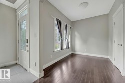 Entryway featuring baseboards and dark wood-style floors - 