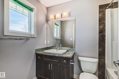 Bathroom featuring vanity and shower / bath combination with curtain - 1669 Hammond Crescent, Edmonton, AB - Indoor Photo Showing Bathroom