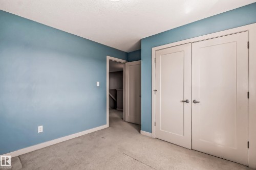 Unfurnished bedroom featuring light colored carpet and a closet - 1669 Hammond Crescent, Edmonton, AB - Indoor Photo Showing Other Room