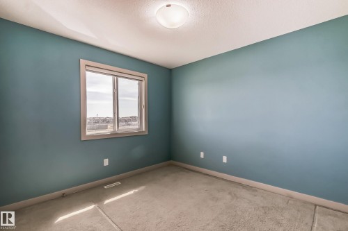 Empty room with light colored carpet and a textured ceiling - 1669 Hammond Crescent, Edmonton, AB - Indoor Photo Showing Other Room
