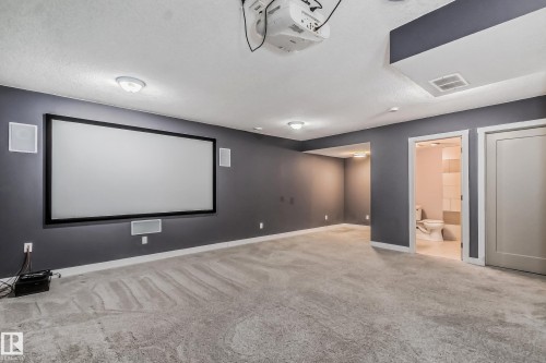 Cinema room featuring light carpet and baseboards - 1669 Hammond Crescent, Edmonton, AB - Indoor Photo Showing Other Room