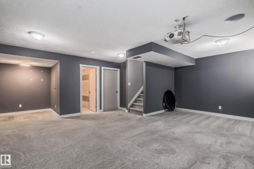 Finished below grade area with light carpet and stairs - 1669 Hammond Crescent, Edmonton, AB - Indoor