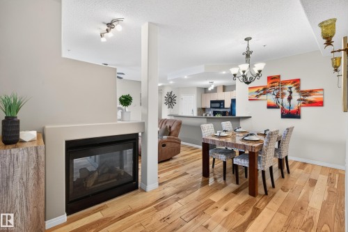 307 5280 Terwillegar Boulevard, Edmonton, AB - Indoor Photo Showing Dining Room With Fireplace
