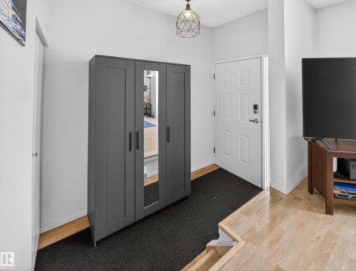 Foyer entrance with baseboards and light wood-style flooring - 4603 32 Avenue, Edmonton, AB - Indoor Photo Showing Other Room