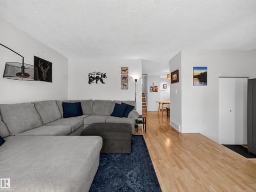 Living room featuring wood finished floors and a textured ceiling - 4603 32 Avenue, Edmonton, AB - Indoor Photo Showing Living Room