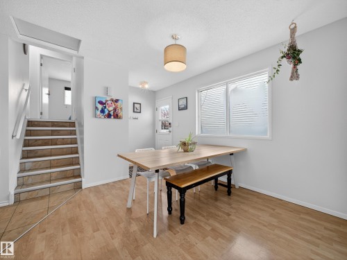 Dining room featuring light wood finished floors and a textured ceiling - 4603 32 Avenue, Edmonton, AB - Indoor Photo Showing Dining Room