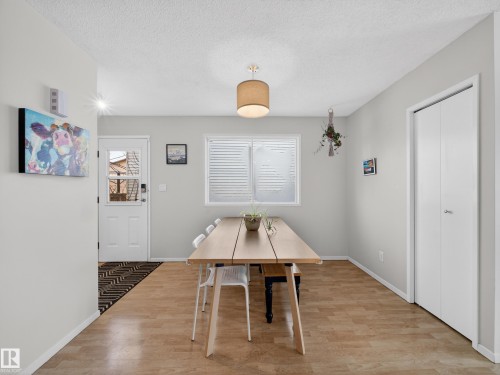 Dining area featuring light wood-type flooring and a textured ceiling - 4603 32 Avenue, Edmonton, AB - Indoor