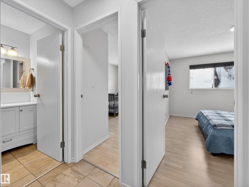 Corridor with a textured ceiling and light wood-type flooring - 4603 32 Avenue, Edmonton, AB - Indoor