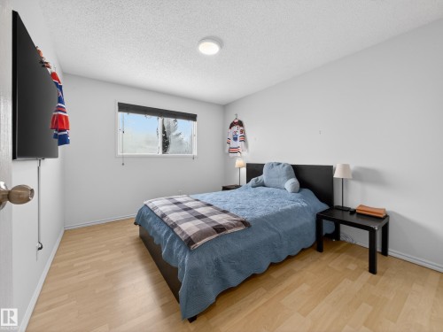 Bedroom with light wood finished floors and a textured ceiling - 4603 32 Avenue, Edmonton, AB - Indoor Photo Showing Bedroom