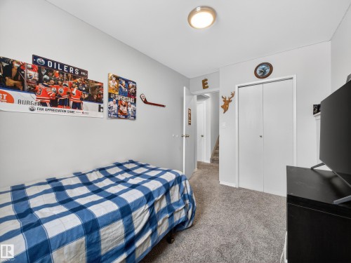 Bedroom with light colored carpet and a closet - 4603 32 Avenue, Edmonton, AB - Indoor Photo Showing Bedroom