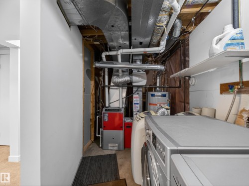 Laundry area featuring washer and clothes dryer, water heater, and concrete floors - 4603 32 Avenue, Edmonton, AB - Indoor Photo Showing Laundry Room