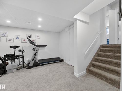 Exercise room featuring light carpet, recessed lighting, and a drop ceiling - 4603 32 Avenue, Edmonton, AB - Indoor Photo Showing Gym Room