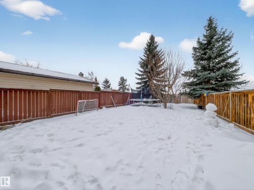 Snowy yard with a trampoline and a fenced backyard - 4603 32 Avenue, Edmonton, AB - Outdoor