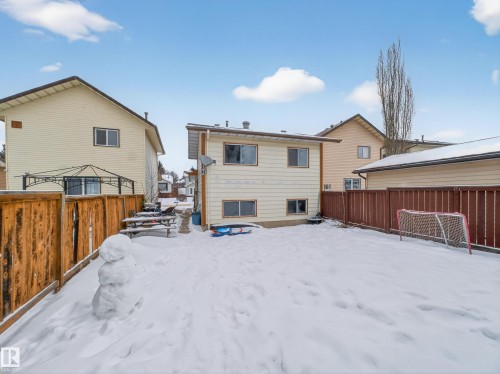 Snow covered back of property with a fenced backyard - 4603 32 Avenue, Edmonton, AB - Outdoor With Exterior